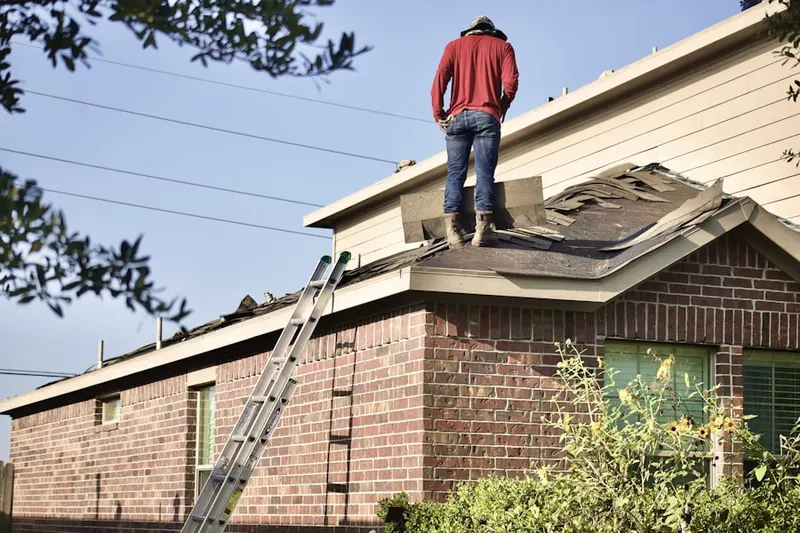 Professional roofer working on a residential roof in Westpark